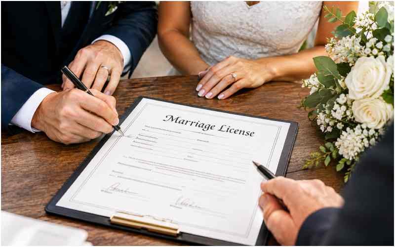 Couple signing a marriage license after the wedding ceremony